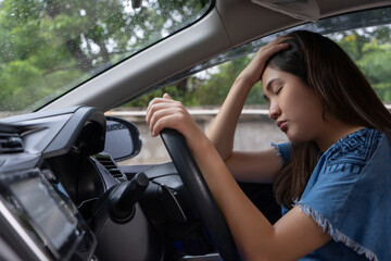 woman distressed in driver's seat of car